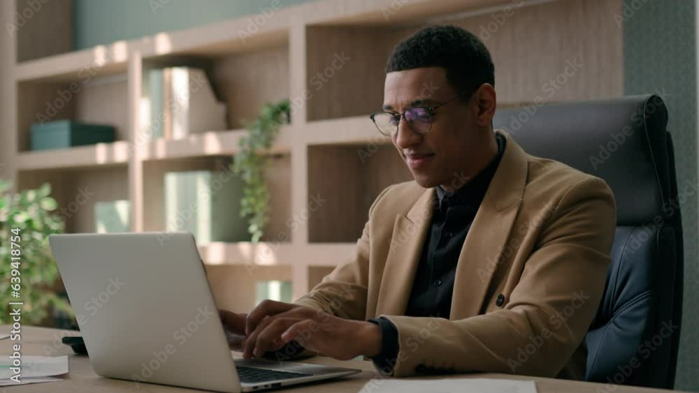 Businessman African American ceo employer office worker male entrepreneur working on computer in office smiling business man satisfied good job finish online project studying on laptop achieve success