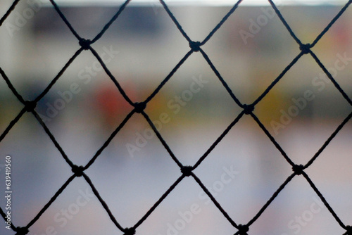 close up of a wire mesh in a basketball court, sport background