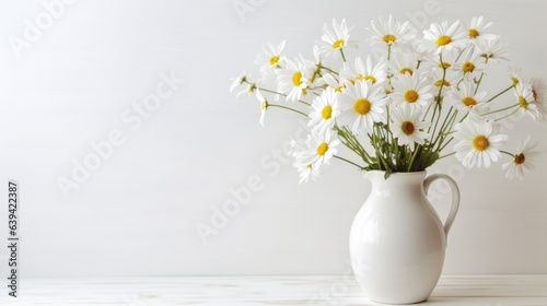 Wallpaper Mural A white vase with daisies on a table in a white room, flowers for Grandmas birthday and womens day in a white space. Torontodigital.ca