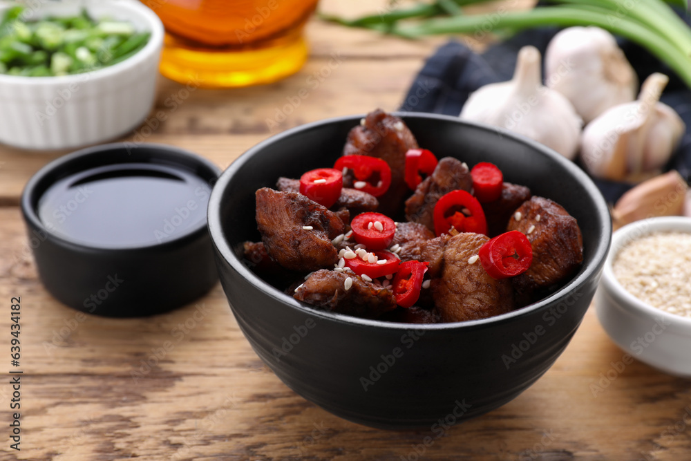 Tasty roasted meat served with soy sauce on wooden table, closeup Tasty roasted meat served with soy sauce on wooden table, closeup
