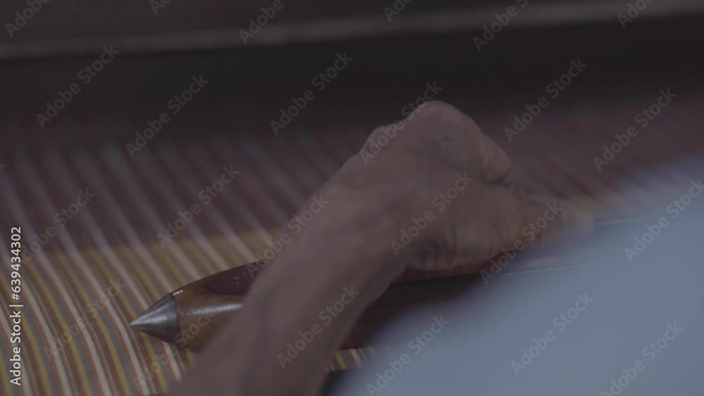 Weaving shuttle on a loom is being repaired Weaving shuttle on a loom is being repaired