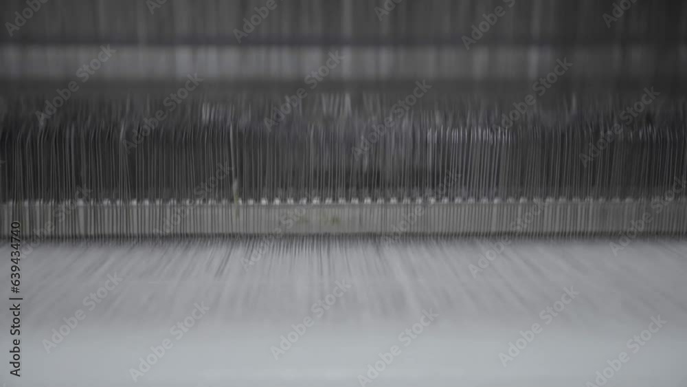 Weaving threads machine, working automatically at a fabric factory