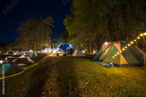 Photography Group outdoor camping tent with tarp or flysheet and Tent lighting, camping tent in the forest under night sky, Tourism concept