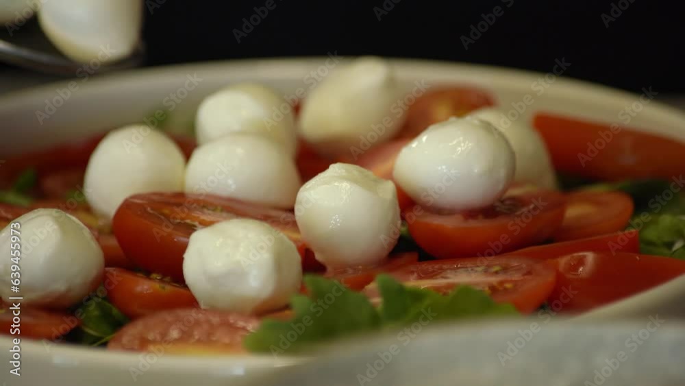 Mozzarella cheese balls and red cherry tomato, Turning. selective focus