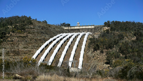Fototapeta Naklejka Na Ścianę i Meble -  Landscape View of the White Pressure Pipes used to channel Water to Environmentally Friendly Hydro electric power station