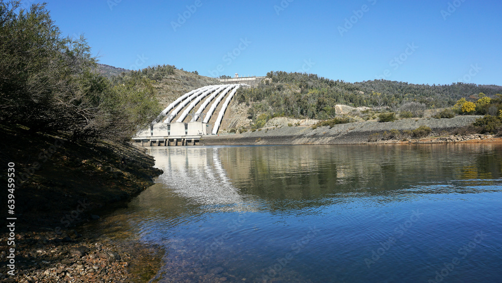 Landscape View of the White Pressure Pipes used to channel water to Environmentally Friendly Pumped Hydroelectric power station	
