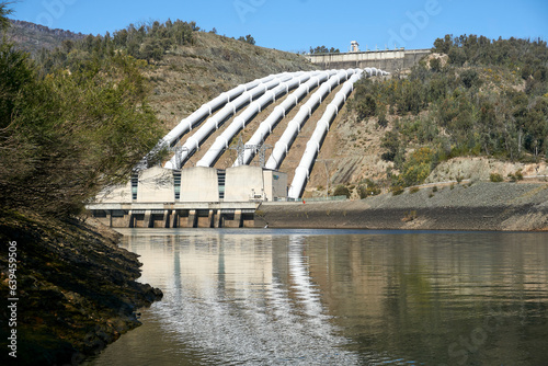 Fototapeta Naklejka Na Ścianę i Meble -  Landscape View of the White Pressure Pipes used to channel water to Environmentally Friendly Pumped Hydroelectric power station	