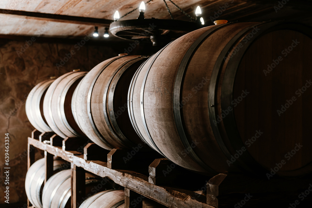 Wine wooden barrels in the cellar of a winery