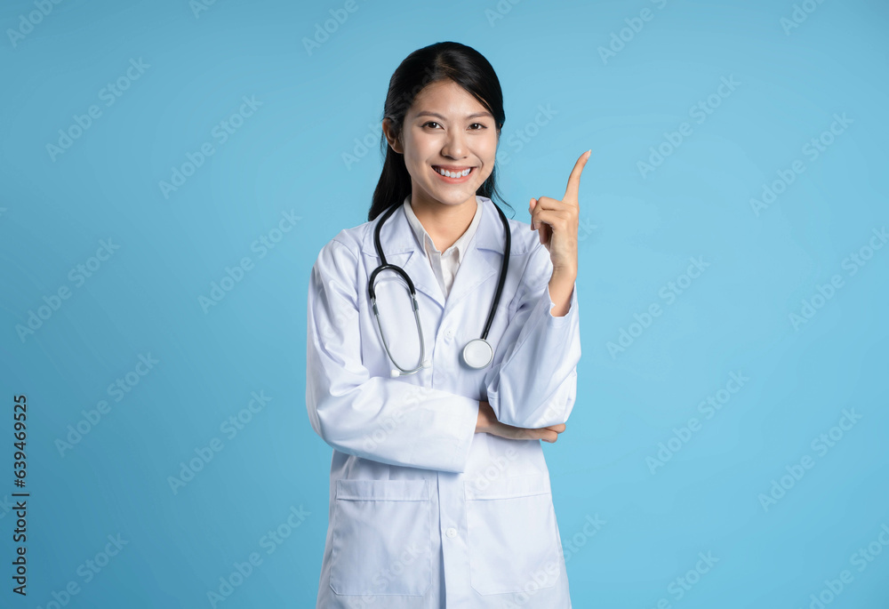 image of asian female doctor posing on blue background image of asian female doctor posing on blue background