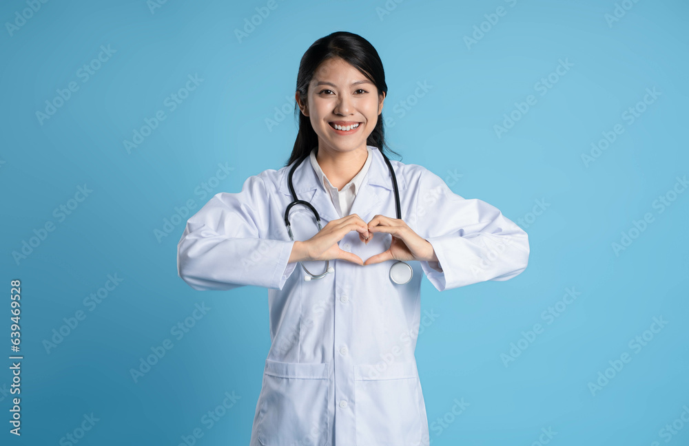 image of asian female doctor posing on blue background image of asian female doctor posing on blue background