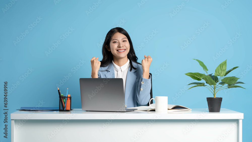 image of asian businesswoman sitting and using laptop on desk image of asian businesswoman sitting and using laptop on desk