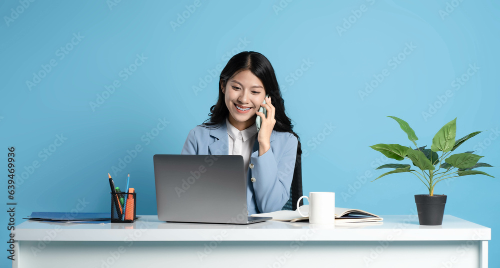 image of asian businesswoman sitting and using laptop on desk image of asian businesswoman sitting and using laptop on desk