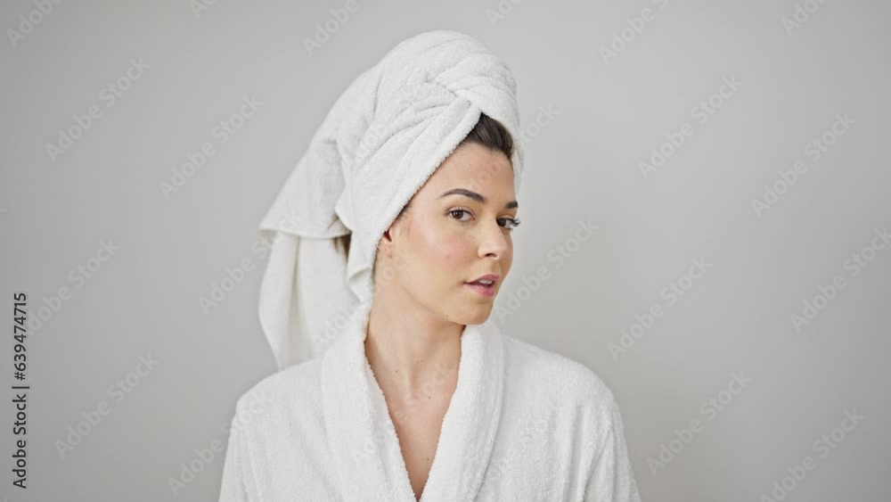 Young beautiful hispanic woman wearing bathrobe smiling over isolated white background Young beautiful hispanic woman wearing bathrobe smiling over isolated white background