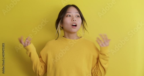crazy woman looks around, cannot believe in success, victory, winning Unbelivable day, bargain, shopping, Slow motion people emotions, teenager shouting, closing her mouth, standing with hands on hips photo