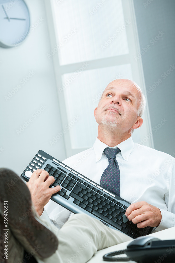 Businessman mimics guitar, uses keyboard, daydreams Businessman mimics guitar, uses keyboard, daydreams