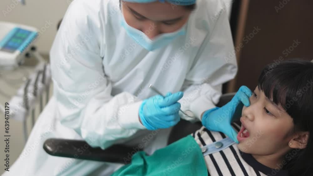 Children's dentistry for healthy teeth .Close-up happy little child asian girl smiles looking at camera, sitting in dentist's chair, receiving dental. Children's dentistry for healthy teeth .Close-up happy little child asian girl smiles looking at camera, sitting in dentist's chair, receiving dental.