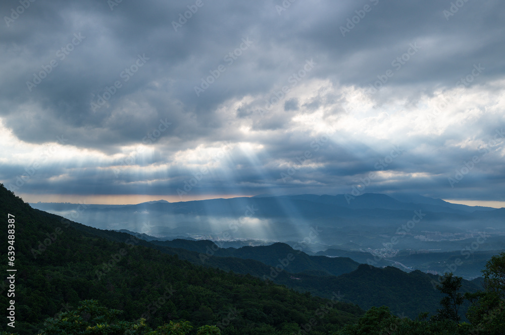 Heavenly Glows: Watch Crepuscular Rays amidst Transforming Clouds on the Peak. The Wufenshan Weather Radar Station stands on the top of the mountain. Taiwan