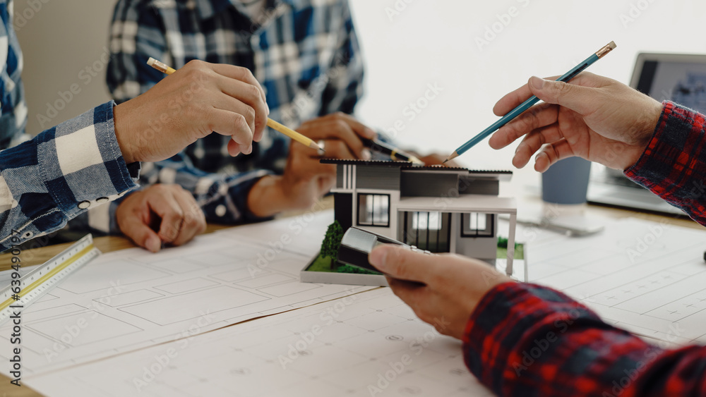 Fototapeta premium 3rd male engineer designing house structure on table in office