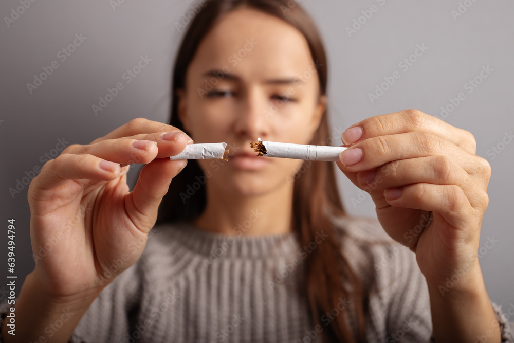 teenager breaks a cigarette, rejection of tobacco, stop smoking teenager breaks a cigarette, rejection of tobacco, stop smoking
