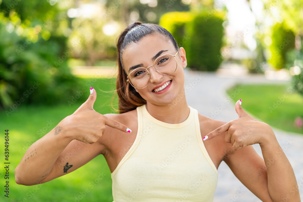Young pretty woman with glasses at outdoors proud and self-satisfied Young pretty woman with glasses at outdoors proud and self-satisfied