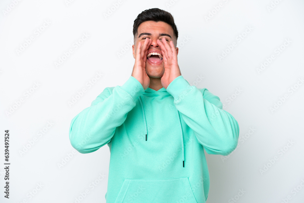 Young caucasian handsome man isolated on white background shouting and announcing something Young caucasian handsome man isolated on white background shouting and announcing something
