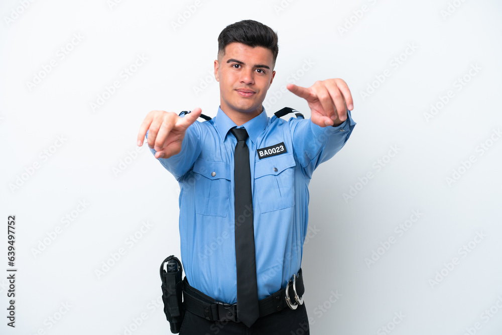Young police caucasian man isolated on white background points finger at you while smiling Young police caucasian man isolated on white background points finger at you while smiling