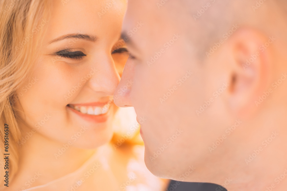 Closeup of bride with gentle makeup looks at groom. the faces of Closeup of bride with gentle makeup looks at groom. the faces of