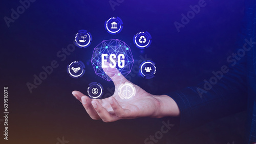 ESG icon concept in the hand for environmental, social and governance in sustainable and ethical business on the Network connection, businessman pressing button on screen.