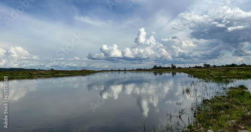 Beautiful landscape with clouds. Summer. River. Poland. Warta. River bank. 