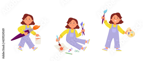 Young Artist girl is painting sitting on the floor, holding big brush and palette of colors