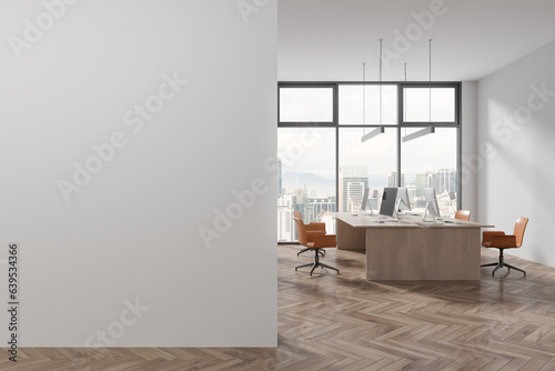 White coworking room interior with pc computer on table in row, mock up wall