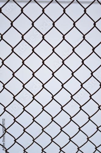 Rusty lattice mesh on a blue background