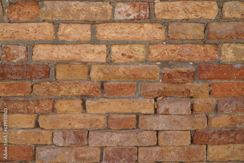 Italian historic site bricks. Brick grunge wall background. Old wall with stained aged bricks.