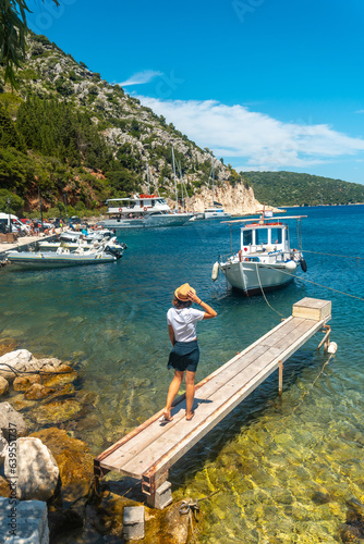 Portrait of a woman walking in the port of Frikes on the island of Ithaki or Ithaca, Ionian sea, Greece photo