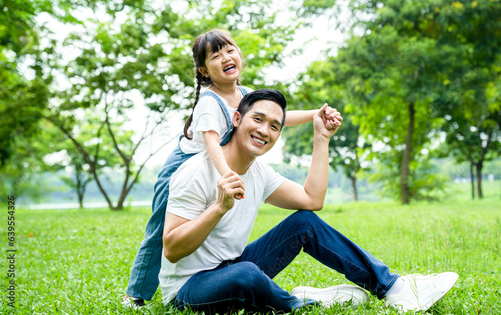 image of father and daughter playing in the park image of father and daughter playing in the park