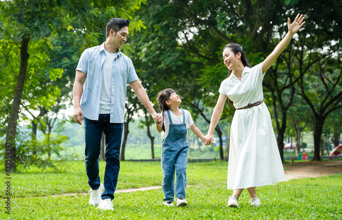 image of asian family walking in the park