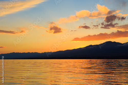 Colorful sea beach over mountains sunrise with deep blue sky and sunbeams. natural background