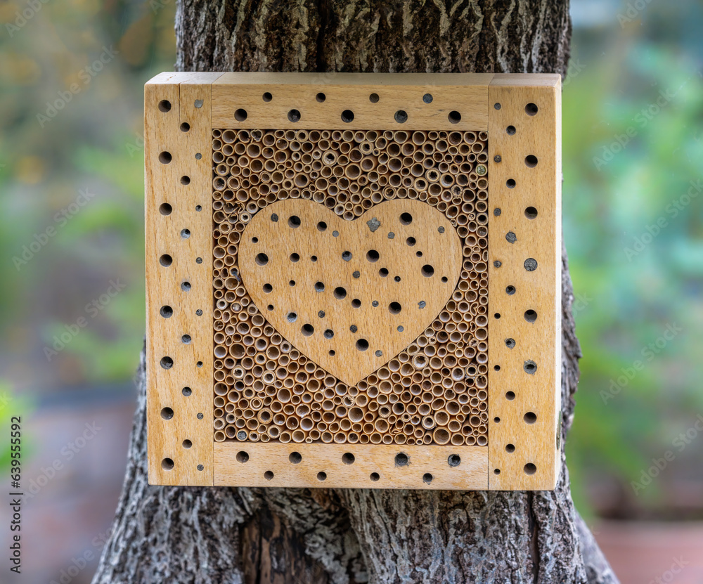 Wooden insect hotel with a heart