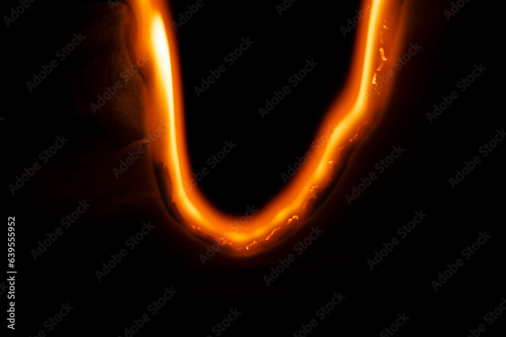 burning paper, glowing edge of paper on a black background burning paper, glowing edge of paper on a black background