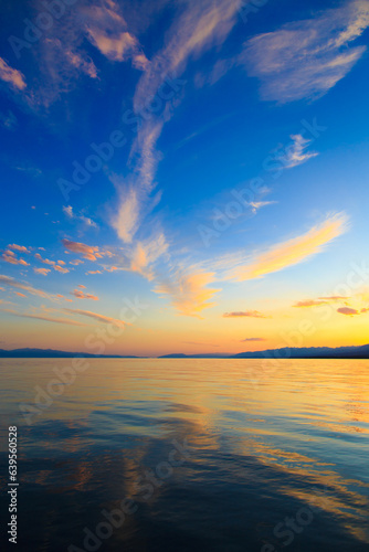 Colorful sea beach over mountains sunrise with deep blue sky and sunbeams. natural background © Alwih
