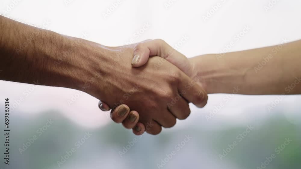 Close up shot of Two people shaking hands or a Man and a Woman Greeting each other with a firm Handshake in a Daylight. Concept of Corporate partnership deal, opportunity, sign of support, agreement Close up shot of Two people shaking hands or a Man and a Woman Greeting each other with a firm Handshake in a Daylight. Concept of Corporate partnership deal, opportunity, sign of support, agreement