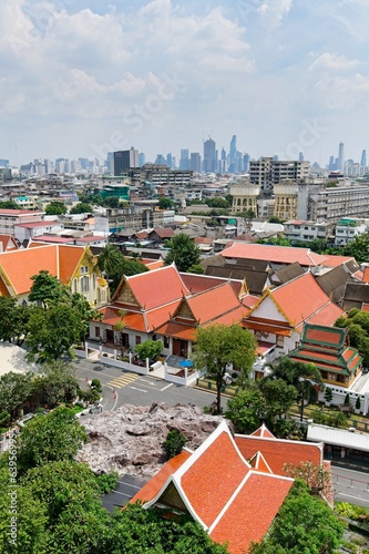 Traditional Thai Architecture with Modern Buildings and Skyscrapers in Background and poor area in the middle of the photo.