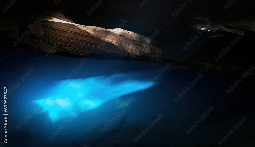 Spectacular Sun Rays Entering a Cave Pool with Clear Blue Water