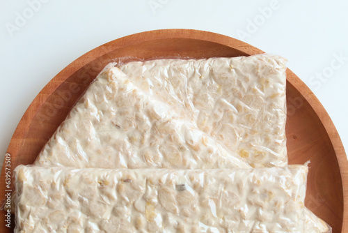 Tempeh or tempe, processed soy product, on wooden background. Isolated on white background. Flat lay or top view photo