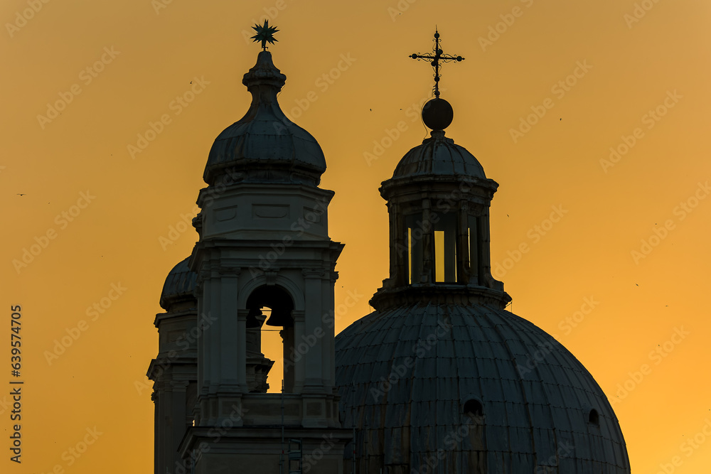 Sunset silhouette of ancient church spires in the Italian city of Venice