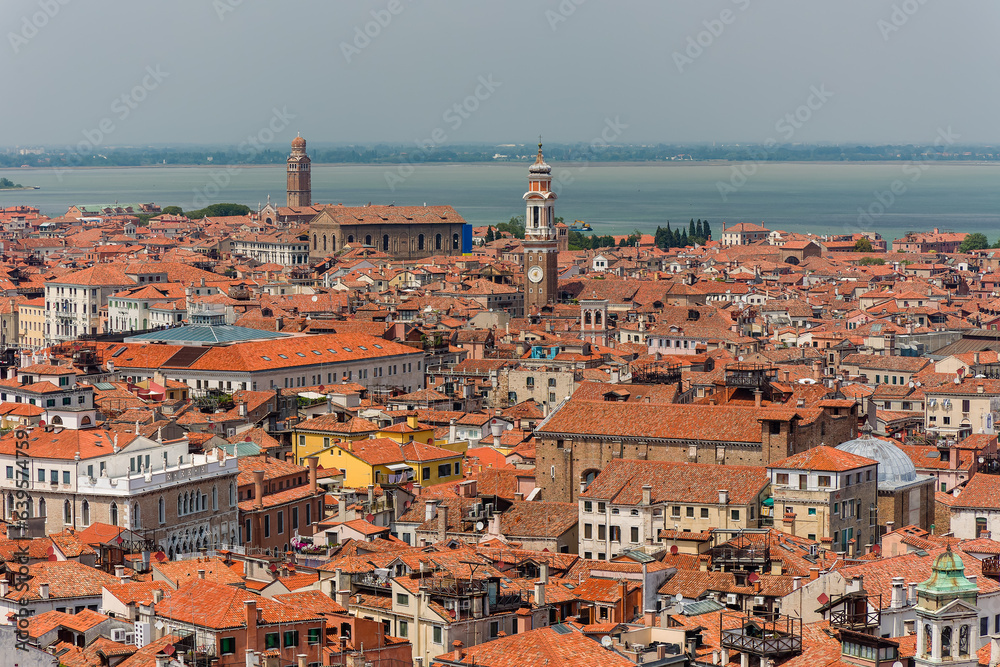 Orange rooftops and ancient church bell towers in the Italian city of Venice
