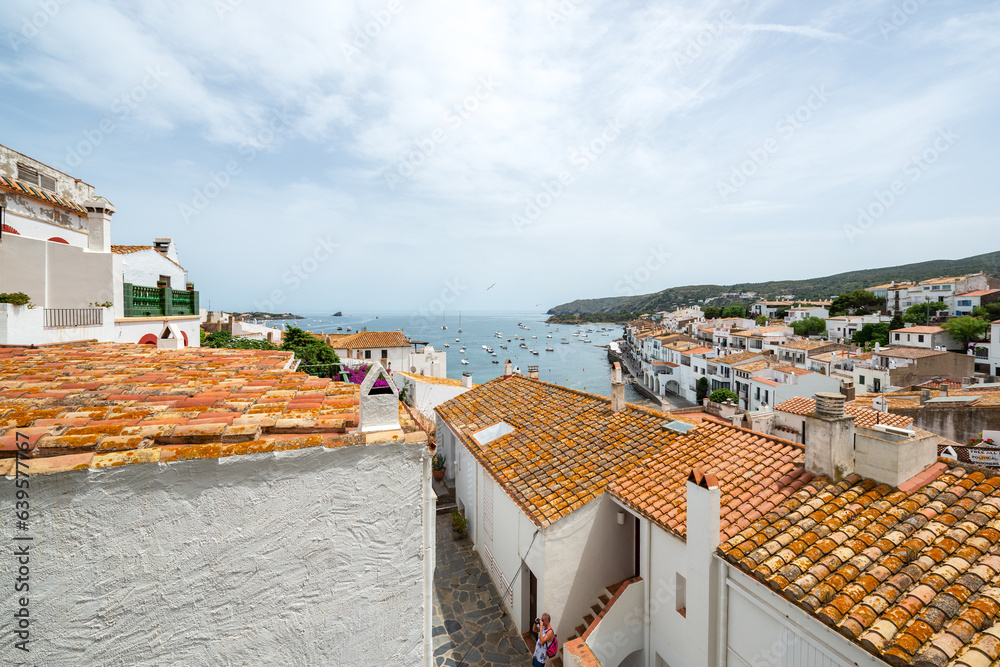 Beautiful view from the terrace over the roofs of traditional townhouses towards the bay Cadaqués town - June 10, 2018 - Costa Brava, Catalonia, Spain