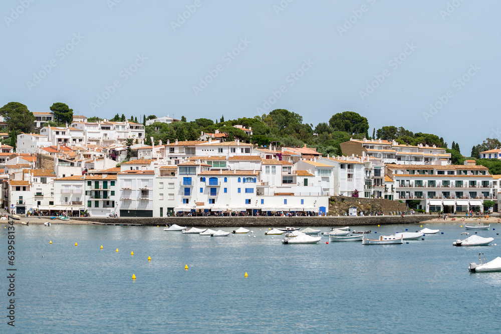 Beautiful view to the white traditional houses and bay with boats of the Cadaqués town - June 10, 2018 - Costa Brava, Catalonia, Spain
