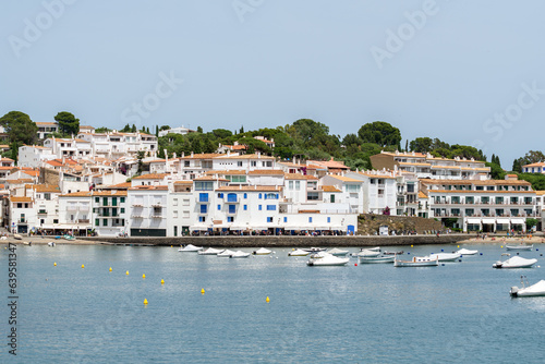 Fototapeta Naklejka Na Ścianę i Meble -  Beautiful view to the white traditional houses and bay with boats of the Cadaqués town - June 10, 2018 - Costa Brava, Catalonia, Spain