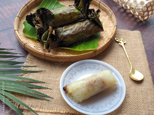 Grilled sticky rice filled with taro in banana leaf - Thai dessert called Khao Niao Ping at close up view  photo